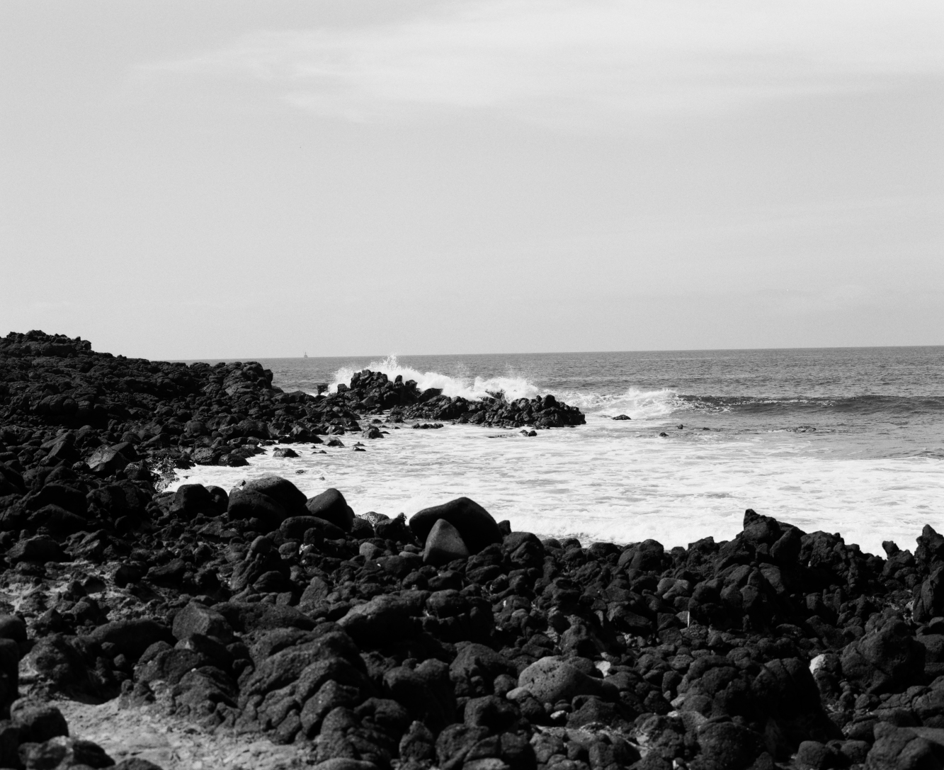 Black and white medium format film photograph of a black rock beach Baja California, Mexico.